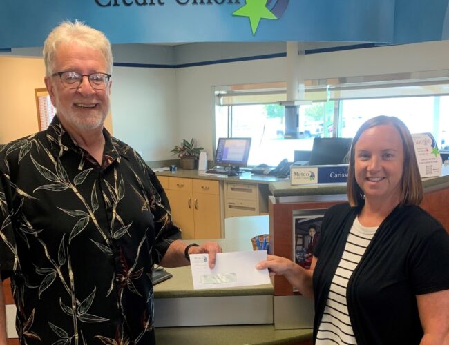 VP Operations giving a check to member